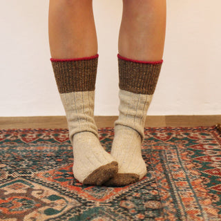 woman wearing Donegal wool socks on a cosy rug