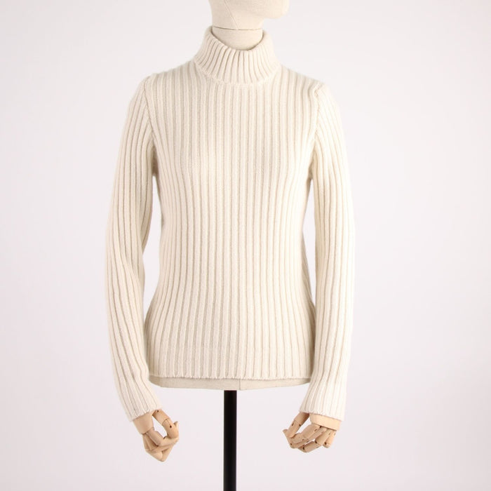 white rib turtleneck sweater on a mannequin against a white background