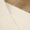 Close-up of a textured fabric with a brown and beige pattern