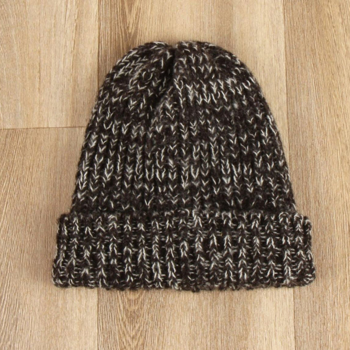 Knitted beanie on a wooden surface