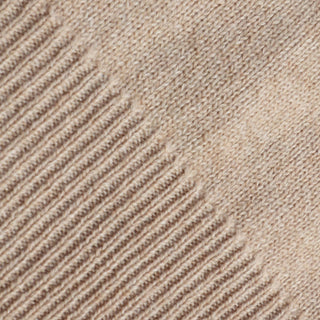 Close-up of a textured beige fabric with rib pattern