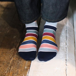 woman wearing striped cotton socks on a wooden floor