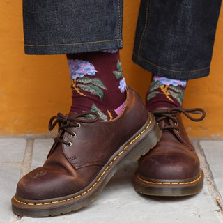 woman wearing floral cotton socks against a yellow wall