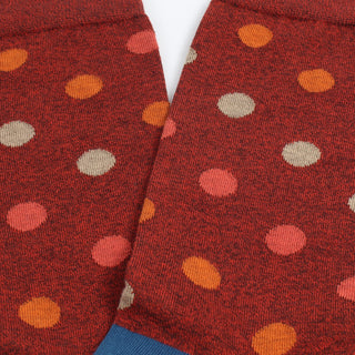 Close-up of red socks with multicoloured polka dot pattern 
