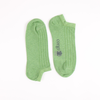 Pair of green socks with a brand logo on a white background