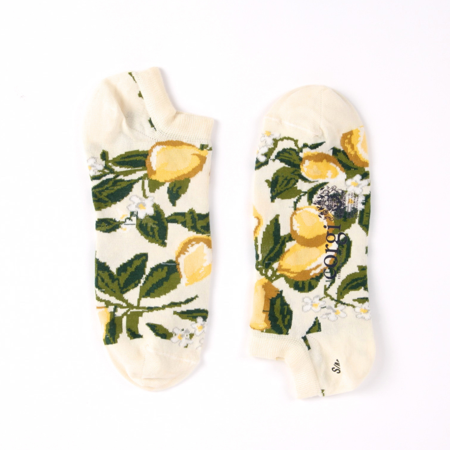 Pair of socks with lemon and leaf pattern on a white background
