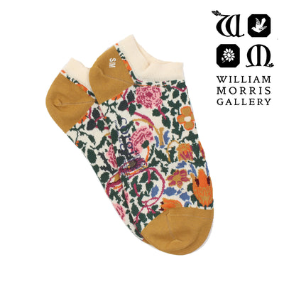 Pair of socks with floral pattern and mustard yellow toes and heels, branded with William Morris Gallery.