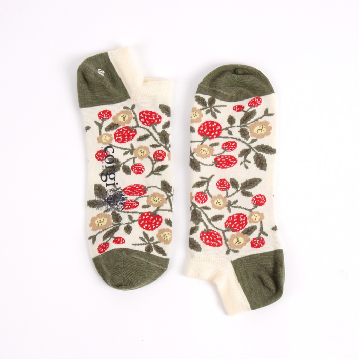 Pair of trainer length socks with red floral patterns and strawberrys on a beige background