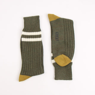 Pair of green socks with two white striped and  mustard yellow accents on the heel and toe, photographed on a white background
