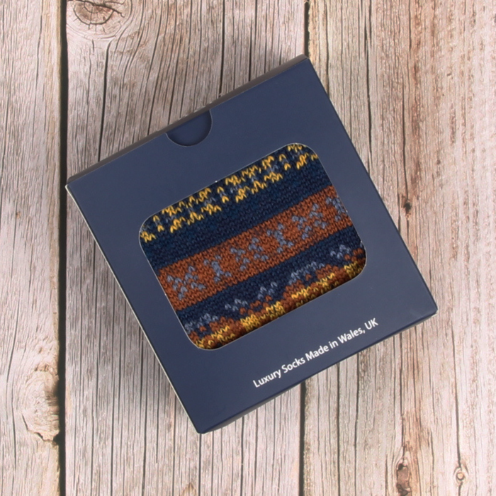Box of luxury socks with a pattern on a wooden surface