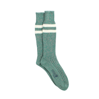 Green sock with white stripes photographed on a white background
