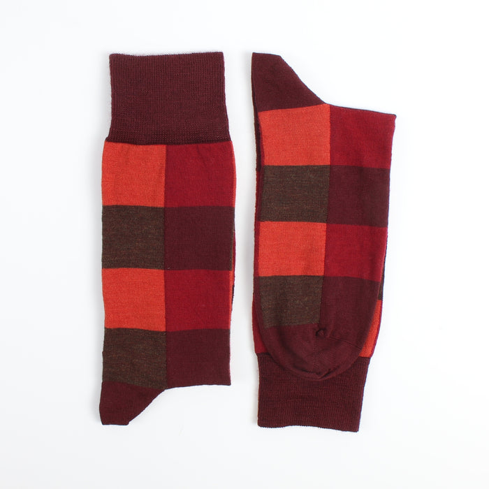 Red and brown checkered socks on a white background