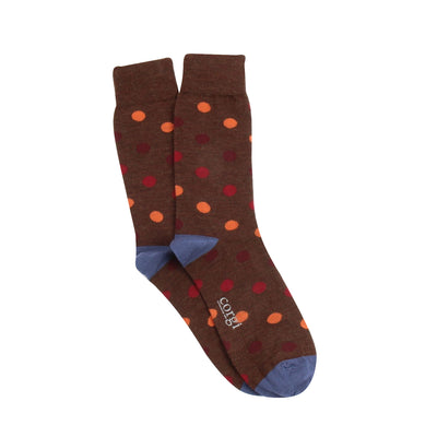 Brown socks with colourful polka dots, blue heel and toe photographed on a white background
