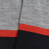Close-up of a fabric with gray,orange and navy stripes.