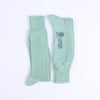Pair of green ribbed socks on a white background with Corgi branding