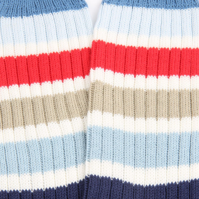 Close-up of striped fabric with red, white, blue, and beige colors.