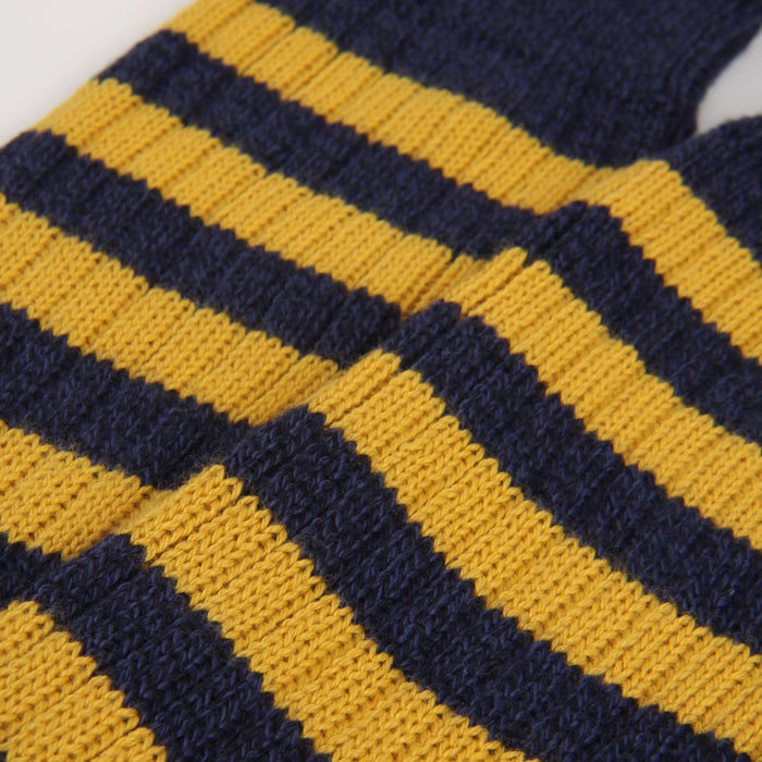 close up of the knitted sock stripe detail in yellow and navy 