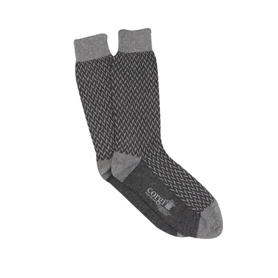 A pair of men's formal socks with a geometric pattern in silver and charcoal colors on a white background