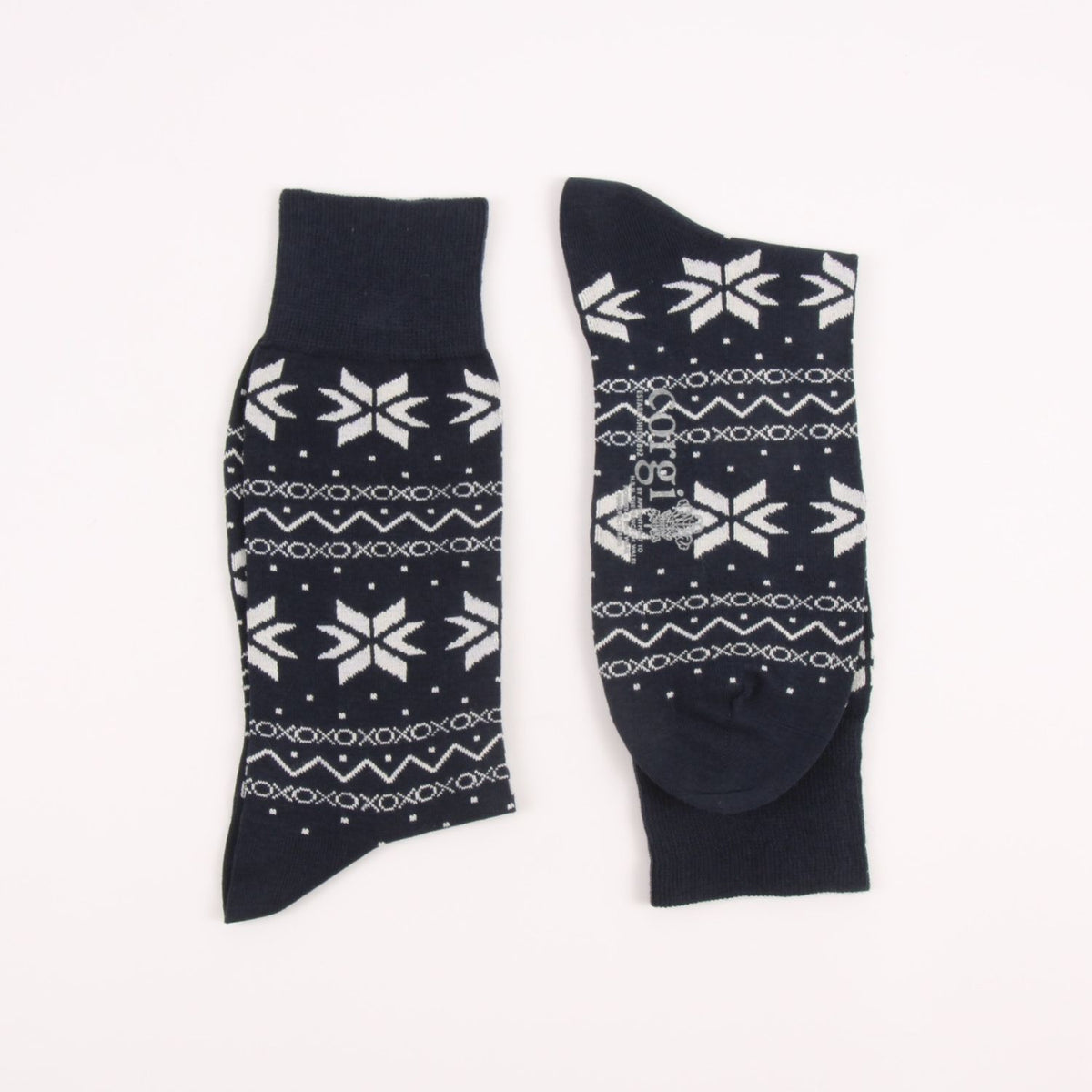 Two navy blue socks with white snowflake patterns on a white background