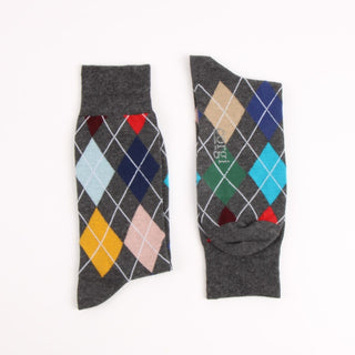 Pair of gray argyle socks with colorful diamond pattern on a white background