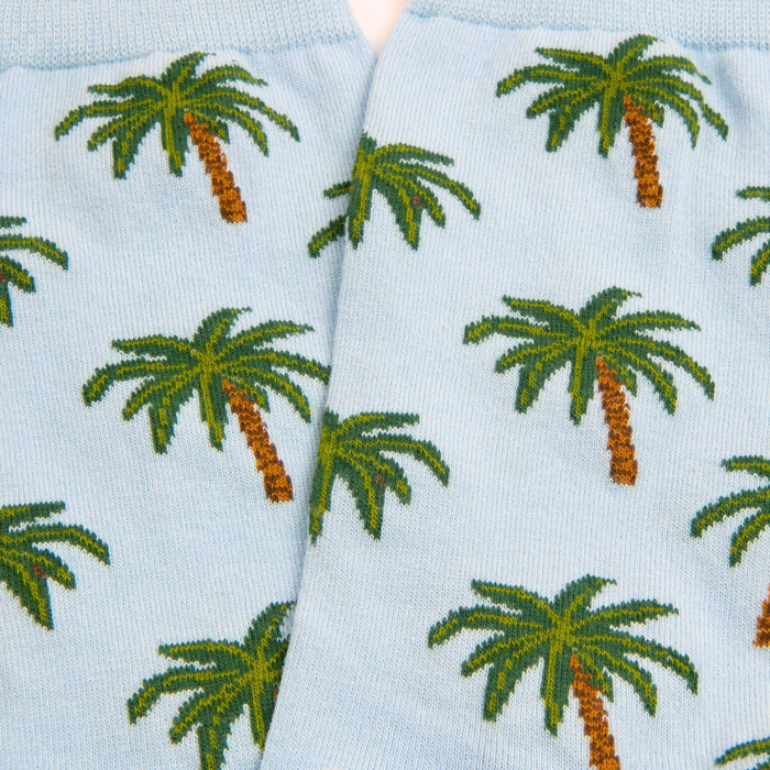 Light blue socks with green palm tree pattern