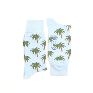 Light blue socks with palm tree pattern on a white background