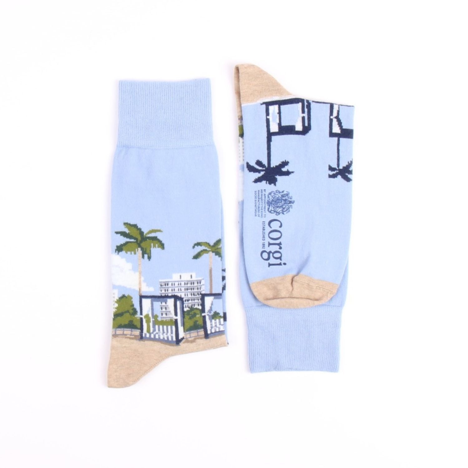 Light blue socks with palm tree and building design on a white background