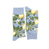 Light blue socks with lemon and leaf pattern on a white background