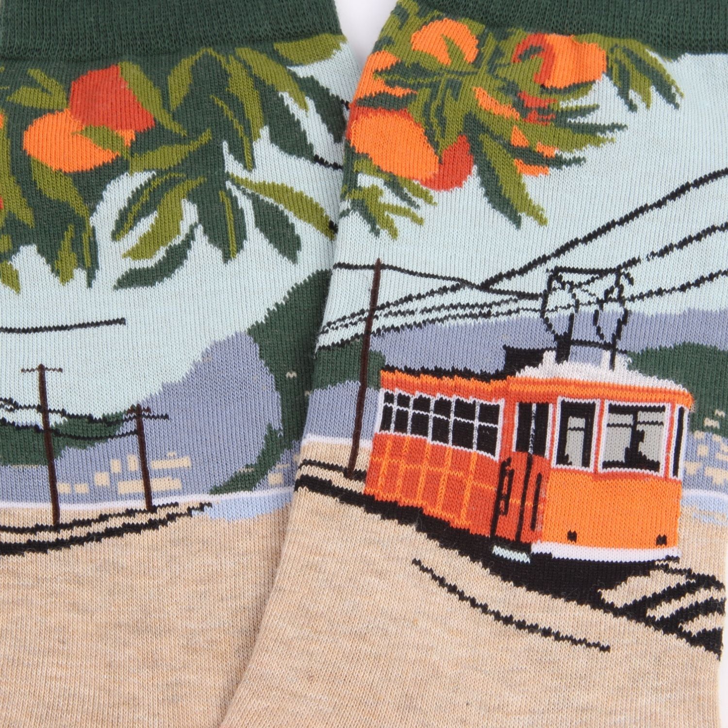 Socks with a cable car and orange trees design on a scenic background
