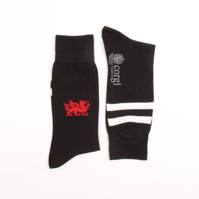 Two black socks with a red dragon emblem and white text on a white background