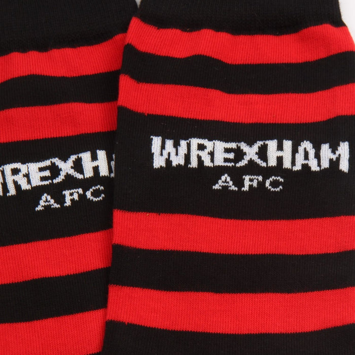Black and red striped socks with 'Wrexham AFC' text on a close-up view.
