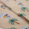 Close-up of fabric with beach-themed mini icons including palm trees and umbrellas.