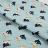 Fabric with mini pelican pattern on a light blue background