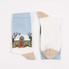 Pair of socks with a winter scene design , photographed on a white background