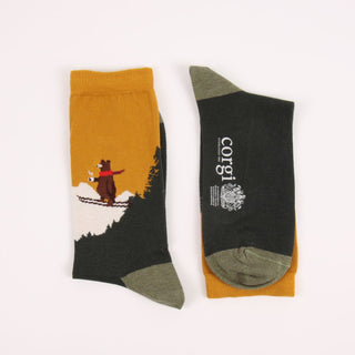 Two socks with skiing bear designs on a white background