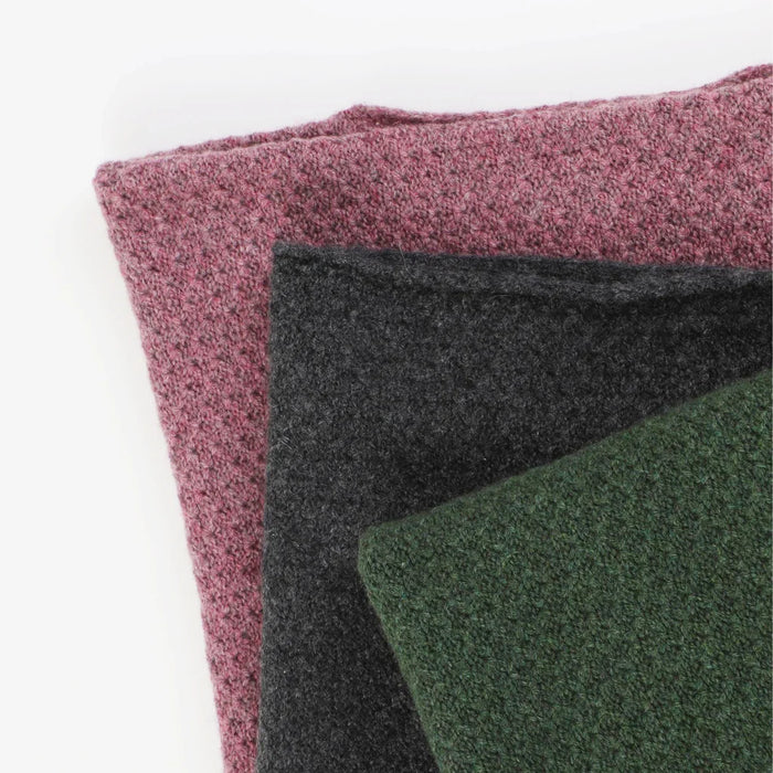 stacked ponchos on a white background