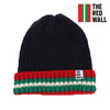 A navy ribbed beanie hat with red and green striped detailing at the brim, featuring the Red Wall logo.