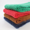 stack of jewel coloured mohair scarves