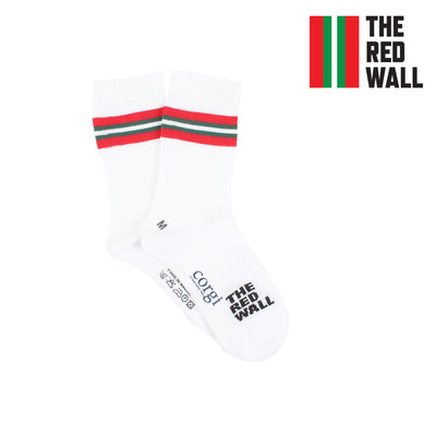 A pair of white crew socks with red and green stripes on the calf, featuring text 'RED WALL' and the flag of Wales.