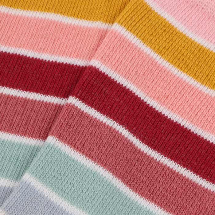 close up of the knitted sock fabric in multiple colours including blue, orange, and pink.