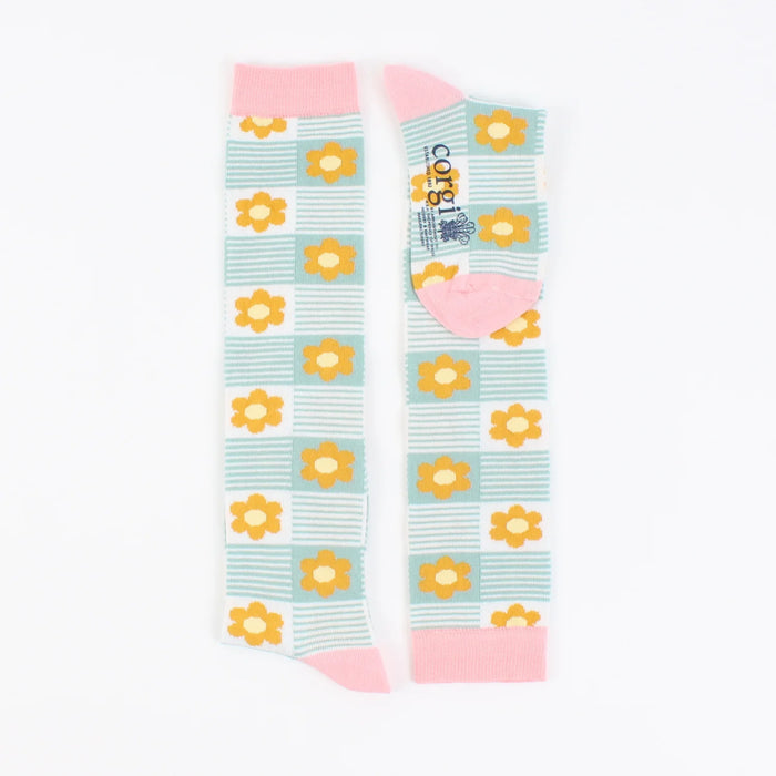 A pair of kids' knee-high socks with a floral pattern in pink and aqua green colours.