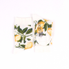 Two socks with lemon and leaf pattern on a white background