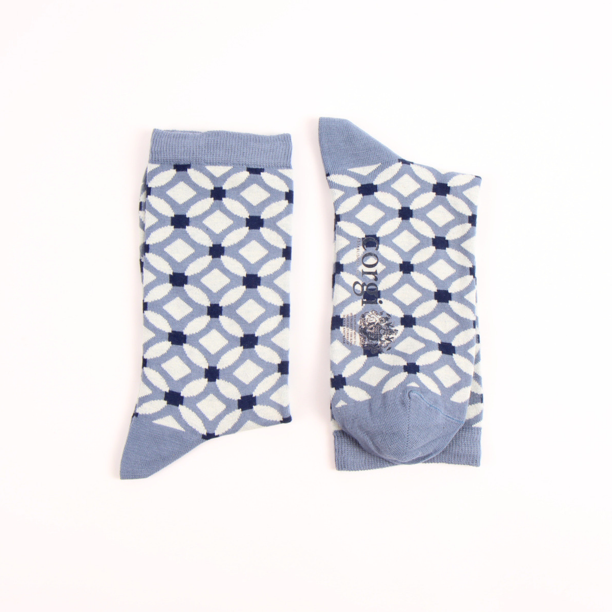 A pair of crew socks with a geometric lattice pattern in navy blue and light blue on a white background, displayed flat on a white surface.