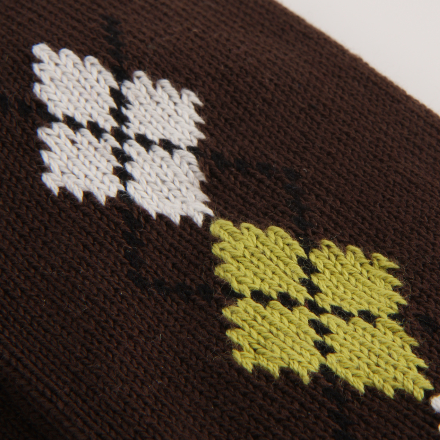 Close-up of a dark brown knit fabric with an argyle motif