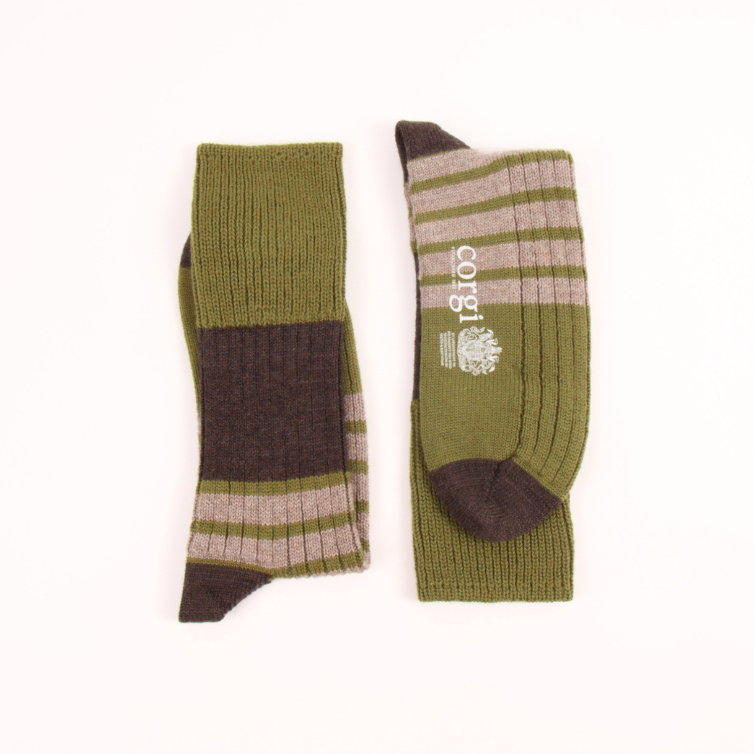 A pair of ribbed knit crew socks in olive green, brown, and beige stripes, displayed flat on a white background. One sock is shown from the side, and the other is shown from the top, featuring a white printed logo on the side.