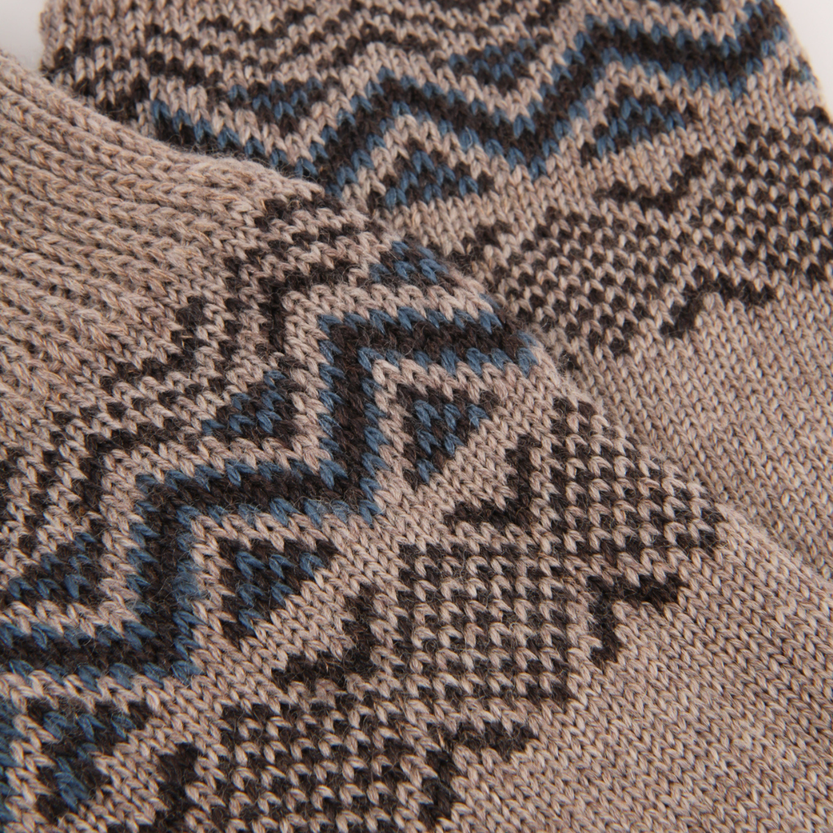 Pair of brown socks with a patterned cuff on a white background