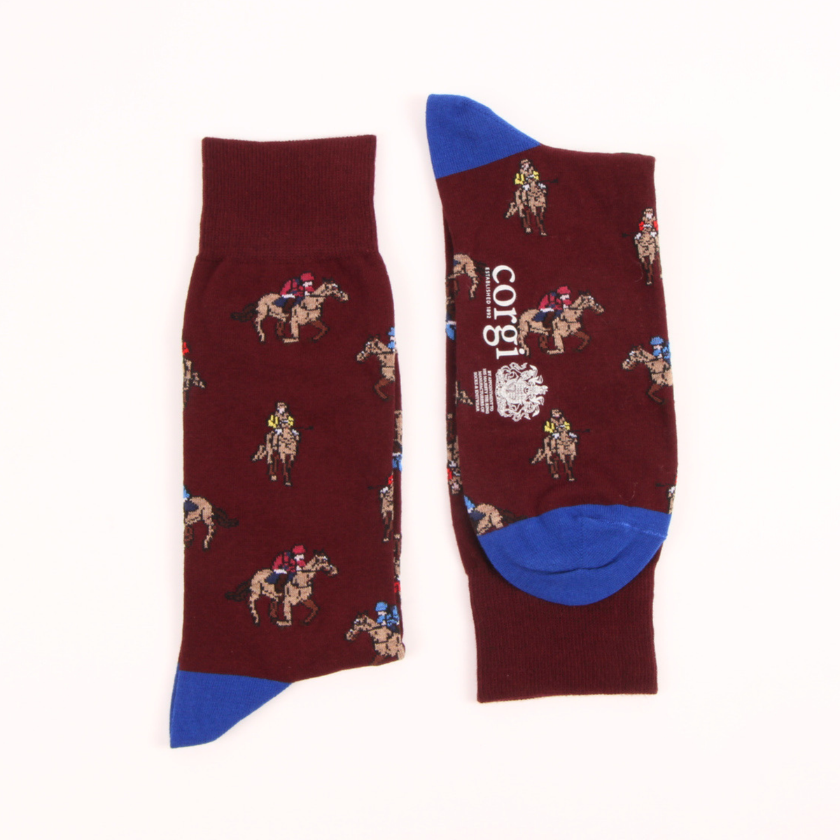 A pair of crew socks in maroon with a jockey and horse pattern, featuring bright blue heels, toes, and cuffs, displayed on a white background.
