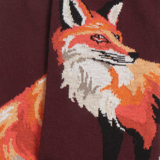 Close-up of a knitted fox design on a fabric background