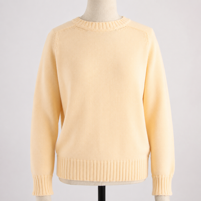 Yellow sweater on a mannequin against a light gray background