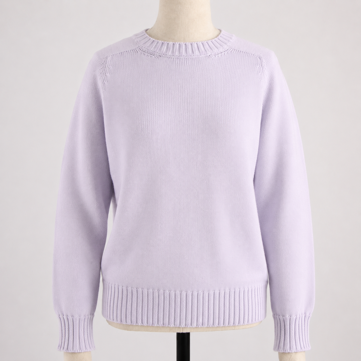 Lavender sweater on a mannequin against a plain background
